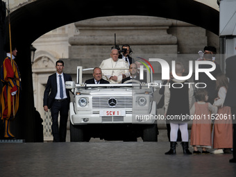 Pope Francis arrives in St. Peter's Square to lead the weekly General Audience in Vatican City on August 28, 2024. (