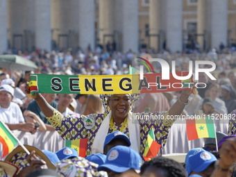 A pilgrim from Senegal attends Pope Francis's weekly general audience in Saint Peter's Square, Vatican City, on August 28, 2024. (