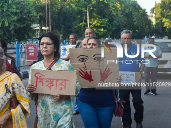 Citizens participate in a protest rally in Kolkata, India, on August 28, 2024, against the rape and murder of a second-year PGT doctor at RG...