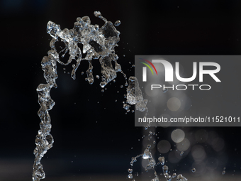 Water from a fountain is seen at Harry Blum Square in Cologne, Germany, on August 28, 2024. (