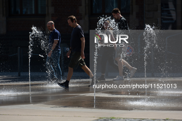 People walk at Harry Blum Square in Cologne, Germany, on August 28, 2024. 