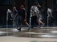 People walk at Harry Blum Square in Cologne, Germany, on August 28, 2024. (