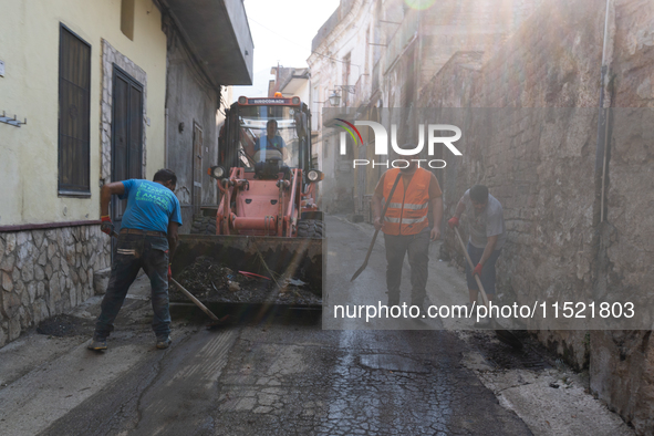 The residents of San Felice a Cancello, in the province of Caserta, deal with the aftermath of the mudslide and water that pour into the tow...