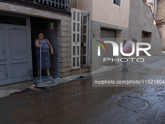 The residents of San Felice a Cancello, in the province of Caserta, deal with the aftermath of the mudslide and water that pour into the tow...