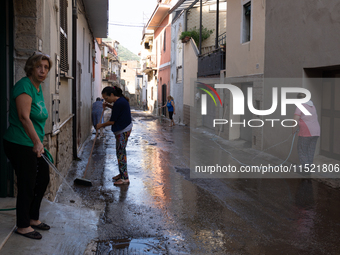 The residents of San Felice a Cancello, in the province of Caserta, deal with the aftermath of the mudslide and water that pour into the tow...