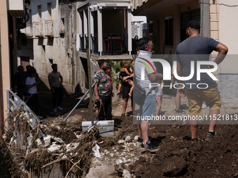 The residents of San Felice a Cancello, in the province of Caserta, deal with the aftermath of the mudslide and water that pour into the tow...