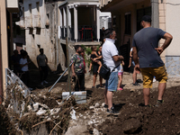 The residents of San Felice a Cancello, in the province of Caserta, deal with the aftermath of the mudslide and water that pour into the tow...