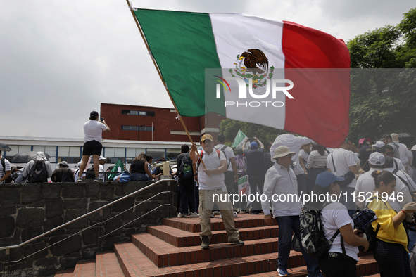 Students and workers of the Faculty of Law of the UNAM wave flags of Mexico in Ciudad Universitaria, Mexico, on August 28, 2024, to protest...