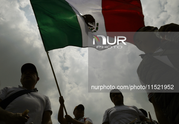 Students and workers of the Faculty of Law of the UNAM wave flags of Mexico in Ciudad Universitaria, Mexico, on August 28, 2024, to protest...