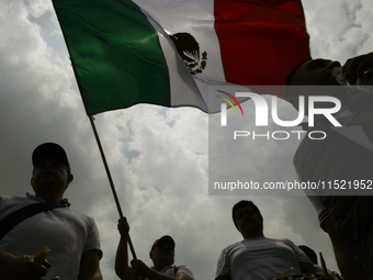 Students and workers of the Faculty of Law of the UNAM wave flags of Mexico in Ciudad Universitaria, Mexico, on August 28, 2024, to protest...