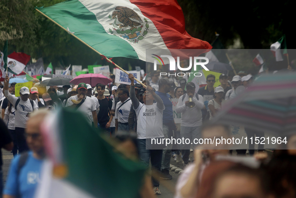 Students and workers of the Faculty of Law of the UNAM wave flags of Mexico in Ciudad Universitaria, Mexico, on August 28, 2024, to protest...