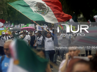 Students and workers of the Faculty of Law of the UNAM wave flags of Mexico in Ciudad Universitaria, Mexico, on August 28, 2024, to protest...