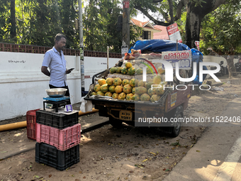 A man sells papayas along the roadside in Thiruvananthapuram (Trivandrum), Kerala, India, on April 16, 2024. (