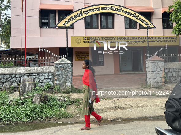 A woman walks past the Kerala Toddy Workers Welfare Fund Board building in Thiruvananthapuram (Trivandrum), Kerala, India, on April 16, 2024...