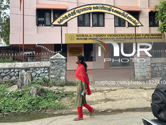 A woman walks past the Kerala Toddy Workers Welfare Fund Board building in Thiruvananthapuram (Trivandrum), Kerala, India, on April 16, 2024...