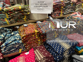 Kurtis are displayed at a discount textile shop in Thiruvananthapuram, Kerala, India, on April 16, 2024. (