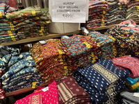 Kurtis are displayed at a discount textile shop in Thiruvananthapuram, Kerala, India, on April 16, 2024. (