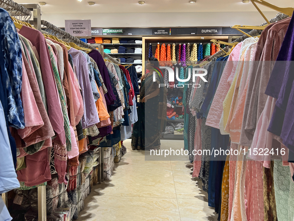 A woman shops for clothing at a textile shop in Thiruvananthapuram, Kerala, India, on April 16, 2024. 