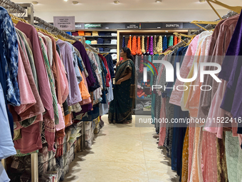 A woman shops for clothing at a textile shop in Thiruvananthapuram, Kerala, India, on April 16, 2024. (