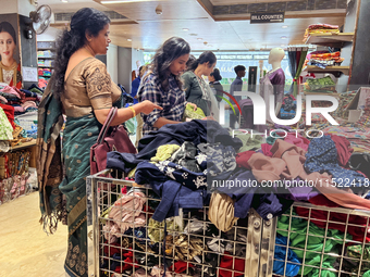 Women shop for clothing at a discount textile shop in Thiruvananthapuram, Kerala, India, on April 16, 2024. (