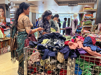 Women shop for clothing at a discount textile shop in Thiruvananthapuram, Kerala, India, on April 16, 2024. (