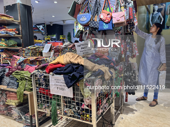 A woman looks at handbags at a textile shop in Thiruvananthapuram, Kerala, India, on April 16, 2024. 