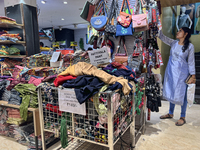 A woman looks at handbags at a textile shop in Thiruvananthapuram, Kerala, India, on April 16, 2024. (