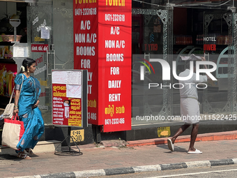 A man covers his head to protect himself from the hot sun while walking along the footpath in Thiruvananthapuram (Trivandrum), Kerala, India...