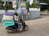 A man carries a load of foam mats on his motorbike in Thiruvananthapuram (Trivandrum), Kerala, India, on April 16, 2024. (