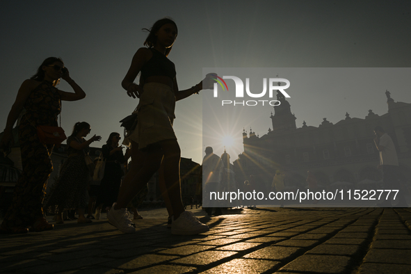 KRAKOW, POLAND - AUGUST 28:
A beautiful sunset and clear blue sky over Krakow's UNESCO Market Square, as Southern Poland and Krakow experien...