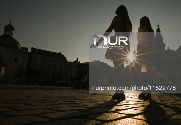 KRAKOW, POLAND - AUGUST 28:
A beautiful sunset and clear blue sky over Krakow's UNESCO Market Square, as Southern Poland and Krakow experien...