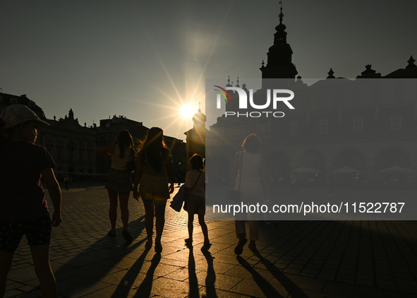 KRAKOW, POLAND - AUGUST 28:
A beautiful sunset and clear blue sky over Krakow's UNESCO Market Square, as Southern Poland and Krakow experien...