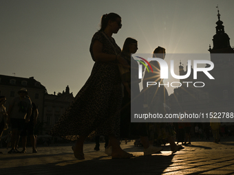 KRAKOW, POLAND - AUGUST 28:
A beautiful sunset and clear blue sky over Krakow's UNESCO Market Square, as Southern Poland and Krakow experien...