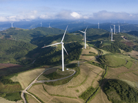 Wind turbines at a high mountain wind farm surrounded by clouds rotate against the wind in Yichang, Hubei province, China, on August 28, 202...