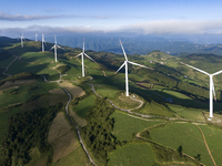 Wind turbines at a high mountain wind farm surrounded by clouds rotate against the wind in Yichang, Hubei province, China, on August 28, 202...