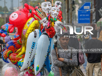 A man sells balloons as it rains in Srinagar, Jammu and Kashmir, on August 29, 2024. (