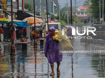 An elderly man wears a raincoat as it rains in Srinagar, Jammu and Kashmir, on August 29, 2024. (