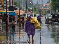 An elderly man wears a raincoat as it rains in Srinagar, Jammu and Kashmir, on August 29, 2024. (