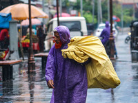 An elderly man wears a raincoat as it rains in Srinagar, Jammu and Kashmir, on August 29, 2024. (