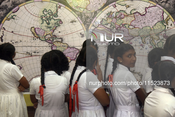 Sri Lankan school children watch a replica World Map by Johannes van Loon in Negombo, Sri Lanka, on August 29, 2024. Johannes van Loon (circ...