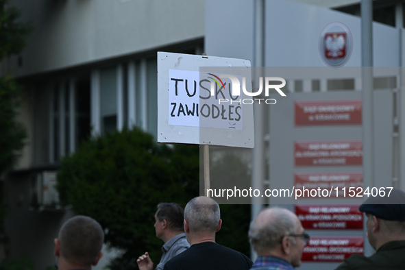 KRAKOW, POLAND - AUGUST 28:
An activist holds a placard reading 'Tusk, you have failed' as members of the KOD (Committee for the Defense of...