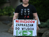 KRAKOW, POLAND - AUGUST 28:
An activist holds a placard reading 'Neo-Judges, please step down' as members of the KOD (Committee for the Defe...