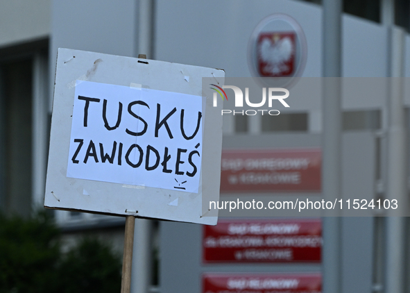 KRAKOW, POLAND - AUGUST 28:
An activist holds a placard reading 'Tusk, you have failed' as members of the KOD (Committee for the Defense of...