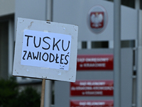 KRAKOW, POLAND - AUGUST 28:
An activist holds a placard reading 'Tusk, you have failed' as members of the KOD (Committee for the Defense of...