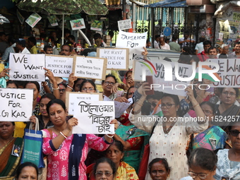 Women participate in ''Journey of Commitment'' during a protest march against the rape and murder of a PGT woman doctor at Government-run R...