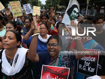 Women participate in ''Journey of Commitment'' during a protest march against the rape and murder of a PGT woman doctor at Government-run R...