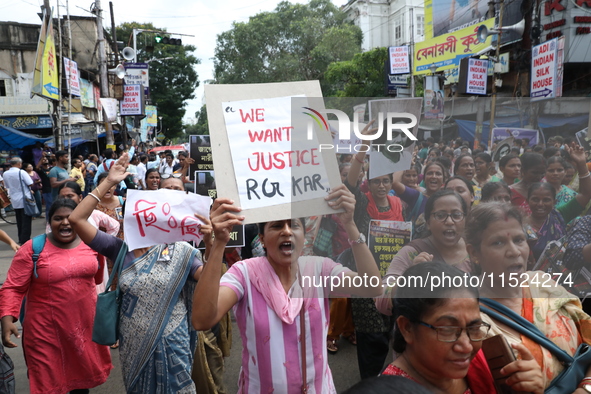 Women participate in ''Journey of Commitment'' during a protest march against the rape and murder of a PGT woman doctor at Government-run R...