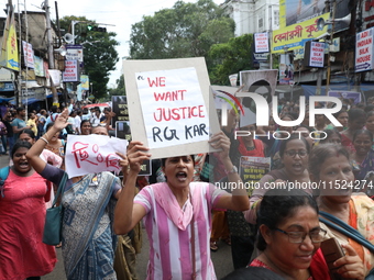 Women participate in ''Journey of Commitment'' during a protest march against the rape and murder of a PGT woman doctor at Government-run R...