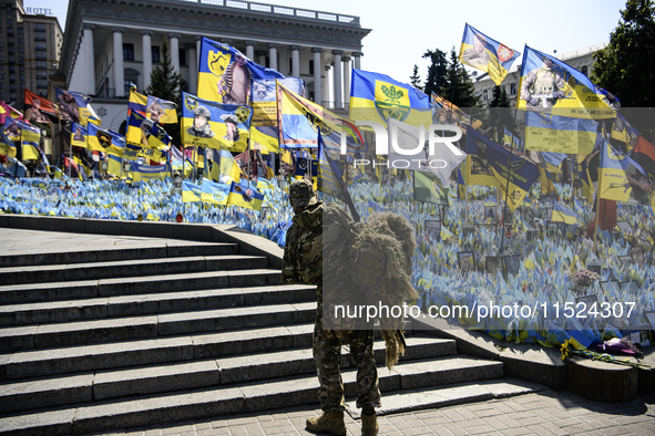 A Ukrainian serviceman commemorates his brothers-in-arms at a makeshift memorial for fallen Ukrainian soldiers on the Day of Remembrance of...