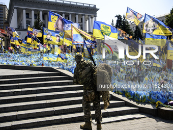 A Ukrainian serviceman commemorates his brothers-in-arms at a makeshift memorial for fallen Ukrainian soldiers on the Day of Remembrance of...